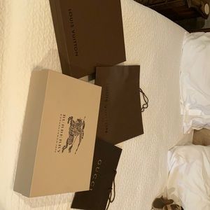 Louis Vuitton, Burberry, and Gucci boxes/bags.